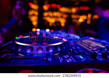 Professional dj mixer controller with lights at nightclub party close up
