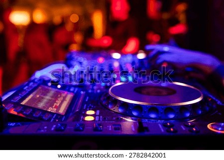 Professional dj mixer controller with lights at nightclub party close up