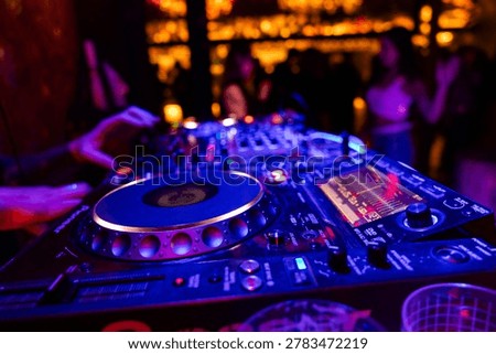 Professional dj mixer controller with lights at nightclub party close up