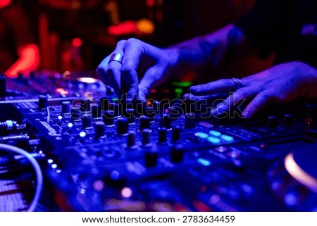 Professional dj mixer controller with lights at nightclub party close up