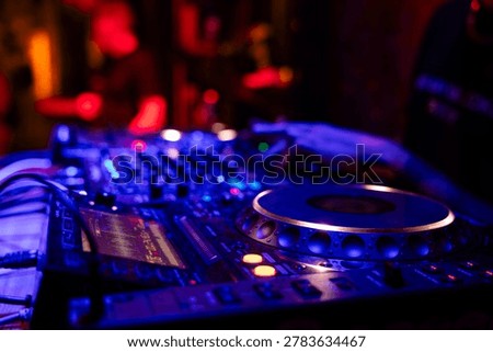 Professional dj mixer controller with lights at nightclub party close up