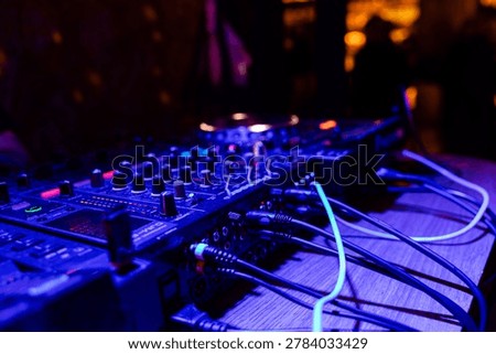 Professional dj mixer controller with lights at nightclub party close up