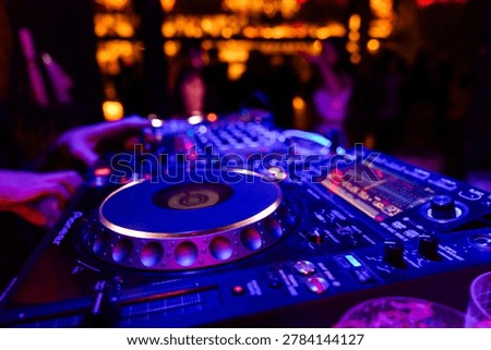 Professional dj mixer controller with lights at nightclub party close up