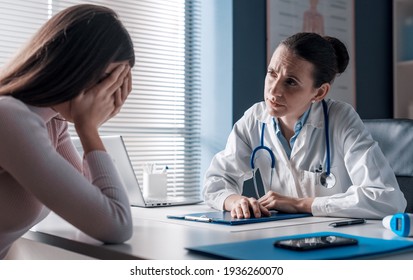 Professional doctor assisting a woman in her office: the patient is crying and feeling hopeless - Powered by Shutterstock