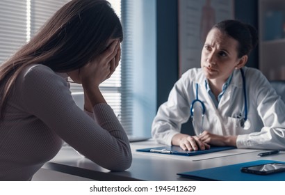 Professional doctor assisting a woman in her office: the patient is crying and feeling hopeless - Powered by Shutterstock