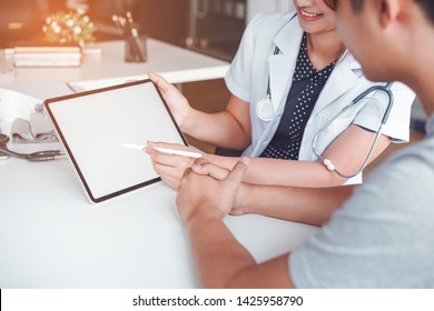 Professional Doctor Reporting Medical Results On Mockup Tablet White Screen To Male Patient At Clinic.Diagnostic, Prevention Of Men Diseases, Medical Service, Consultation, Medical Technology Concept.