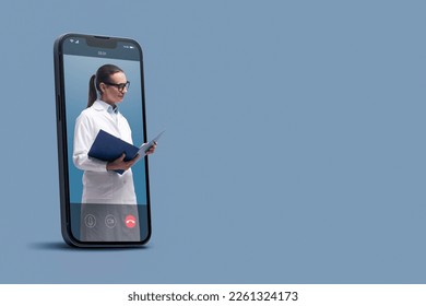 Professional doctor in a smartphone videocall and checking medical records, online doctor and telemedicine concept - Powered by Shutterstock