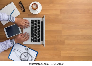 Professional doctor use computer and medical equipment all around, desktop top view with copyspace, coffee