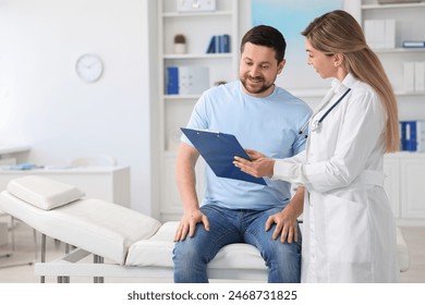 Professional doctor working with patient in hospital, space for text - Powered by Shutterstock