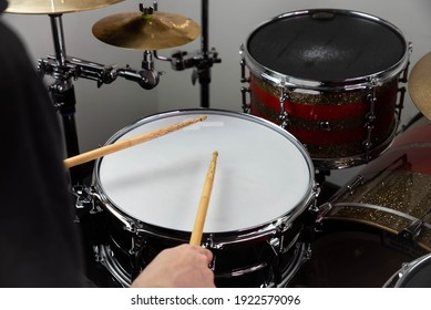 Professional Drum Set Closeup. Man Drummer With Drumsticks Playing Drums And Cymbals, On The Live Music Rock Concert Or In Recording Studio   