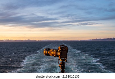 Professional Dslr On Tripod On Back Of Cruise Ship Sailing Away From Alaska Coast Leaving Wake