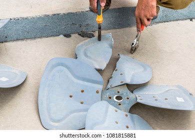 A Professional Electrician Man Is Showing Up The Broken Fans Of Heavy Unit Of An Air Conditioner At The Roof Top Of A Building 