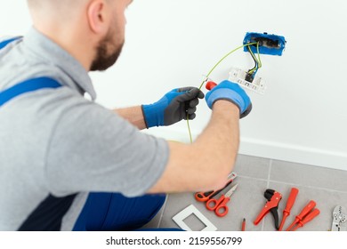 Professional Electrician Working On The Electrical System, Home Improvement And Repair Concept