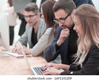 professional employees work on computers in a modern office - Shutterstock ID 1691141209