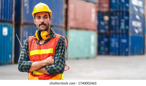 Professional engineer container cargo foreman in helmets working standing and holding walkie talkie look at camara.logistic and business export