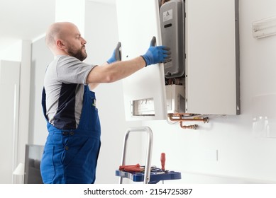 Professional Engineer Doing A Boiler Inspection At Home