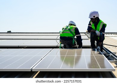 Professional engineer technician with safety helmet checking and operating system at solar cell farm power plant, Renewable energy source for electricity and power, Solar cell maintenance concept - Shutterstock ID 2257157031