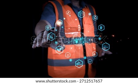 Professional engineer touching virtual interface for net zero and carbon neutral concept. Sustainable industrial development showing green energy technology icons on dark background.