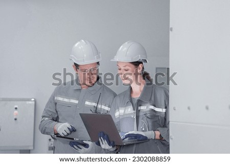Professional engineer workers training and testing machine at industry factory. Concept people operation in industrial. Industry robot programming software for automated manufacturing technology.