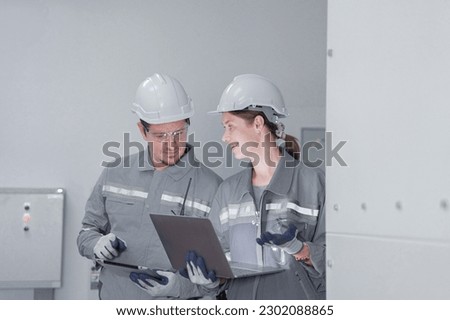 Professional engineer workers training and testing machine at industry factory. Concept people operation in industrial. Industry robot programming software for automated manufacturing technology.