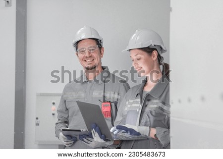 Professional engineer workers training and testing machine at industry factory. Concept people operation in industrial. Industry robot programming software for automated manufacturing technology.