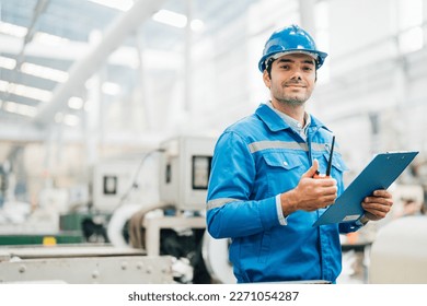 Professional Engineering of modern factory checking  to automatic machinery. Engineering with clipboard Programmable Logic Controller to manage large machine working full automatic. - Shutterstock ID 2271054287