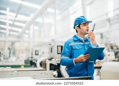 Professional Engineering of modern factory checking  to automatic machinery. Engineering with clipboard Programmable Logic Controller to manage large machine working full automatic. - Powered by Shutterstock