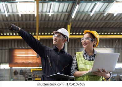 Professional Engineering Workers Walk And Check In Warehouse Factory. Manager Discuss Inspection Report Paper For Internal Audit. Quality Assurance For Manufacturing. Concept Engineer Operating.