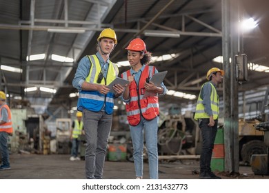 Professional Engineering Workers Walk And Check In Warehouse Factory. Manager Discuss Inspection Report For Internal Audit. Quality Assurance For Manufacturing. Concept Engineer Operating.