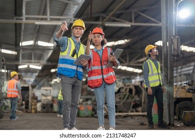 Professional Engineering Workers Walk And Check In Warehouse Factory. Manager Discuss Inspection Report For Internal Audit. Quality Assurance For Manufacturing. Concept Engineer Operating.