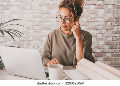 Professional entrepreneur work alone in home office workplace desk with laptop and paper documents. Business online job female people looking laptop display with a smile. Concept of businesswoman - Powered by Shutterstock