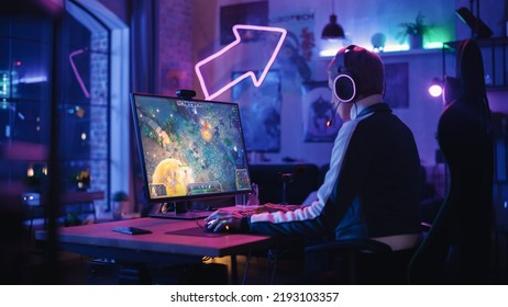 Professional ESports Female Gamer Plays RPG Strategy Video Game With Lots Of Action And Fun On Her Powerful Gaming Personal Computer At Home. Cyber Gaming Stylish Retro Neon Room.