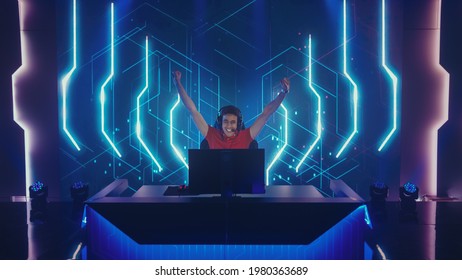 Professional eSports Gamer Playing in Computer Video Games, Happily and Cheerfully Celebrates Victory and Success. Online Cyber Championship  Tournament. Portrait Front View Shot