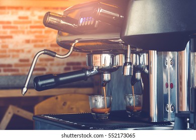 Professional Espresso Machine Brewing A Coffee. Coffee Pouring Into Shot Glasses