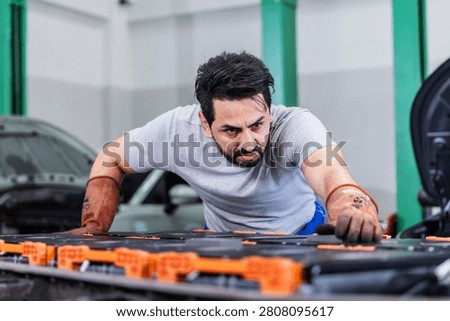 Professional EV technician inspecting high-voltage battery electrical connections inside a modern electric vehicle service center. The technician carefully checks battery connectors and wiring to ensure safety, reliability, and optimal system performance. Concept of electric vehicle diagnostics, battery maintenance, preventive inspection, automotive engineering, and sustainable mobility.