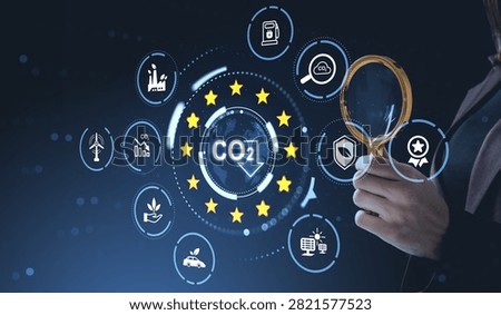 Professional examines carbon reduction data with a magnifying glass, sustainability icons and clean energy symbols on a dark blue background, compliance concept