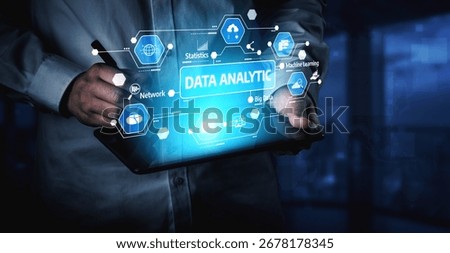 Professional examines tablet device displaying advanced data analytics hologram, emphasizing technology role in modern business strategy and decision making. Tessel
