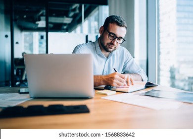 Professional Expert Working With Information For Business Report About Corporate Money Investment Writing Notes In Textbook During Time For Online Researching On Laptop Computer,digital Marketing