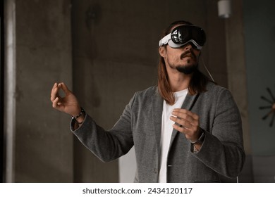 A professional explores the potential of spatial computing with the augmented reality headset in a modern office setting, blending the virtual with the real. - Powered by Shutterstock