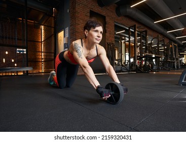 Professional Female Athlete Performing Ab Wheel Rollout