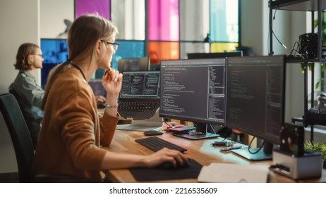 Professional Female Backend Software Developer Coding on Desktop Computer With Two Displays in Creative Office.Caucasian Woman Creating User Data Base for New Social Network Website or Online Store. - Powered by Shutterstock