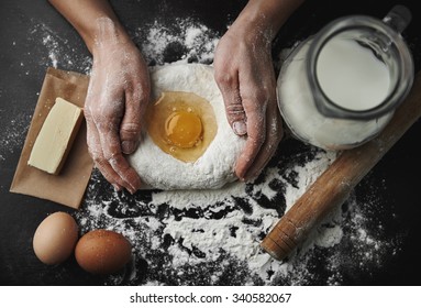 Professional female baker cooking dough with eggs, butter and milk for Christmas cookies.  - Powered by Shutterstock