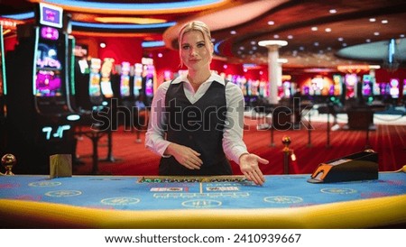 Professional Female Croupier in Casino Dealing Playing Cards on a Baccarat Table. Beautiful Dealer of a Live Online Casino Reveals Winning Results of the Card Game Bets, Looking at the Camera
