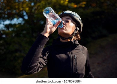 Professional Female Cyclist Drinking Water