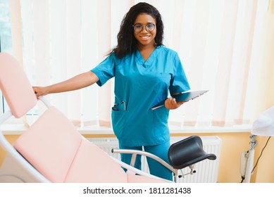 Professional female doctor on blurred consulting room background. African American gynecologist. Gynecology concept.