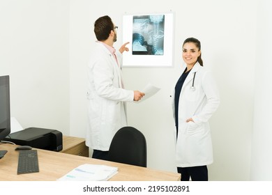 Professional Female Doctor And Radiologist At The Office Checking The X-ray Scans Of A Patient To Give A Medical Interpretation Or Diagnosis