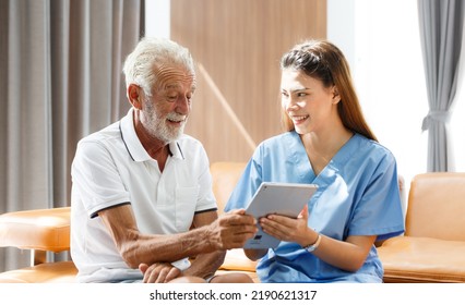 Professional Female Doctor Using Digital Tablet Senior Male Patient Medical Test Results Explain Prescription Using Tablet App Sitting On The Sofa At Home Elderly Health Care Technology Concept