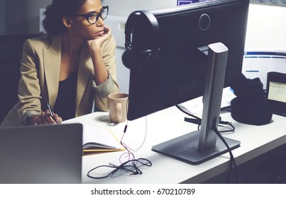 Professional Female Editor Sitting In Studio While Choosing Video For Prime Time Watching Media Materials On Modern Computer Connected To Free Wireless Internet In Newsroom During Working Day 