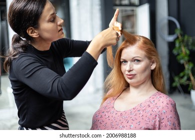 Professional female makeup artist applying cosmetics on model face use brush working at beauty salon. Woman visagist make up master dyeing facial visage to client appearance makeover - Shutterstock ID 2006988188