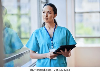 Professional Female Nurse in Scrubs with Digital Tablet at Hospital - Powered by Shutterstock